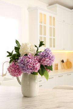 Bouquet with beautiful hydrangea flowers on white marble table