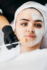 Young beautiful woman with facial mask