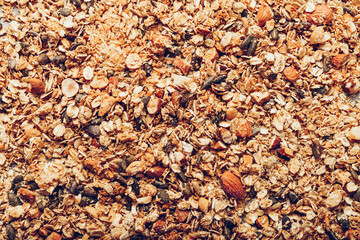 Roasted healthy homemade granola with Gluten Free Rolled oats or porridge oats, variety of chopped nuts and seeds, and maple syrup.