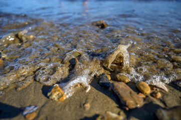 Waves at the seashore. Selective focus with shallow depth of field.