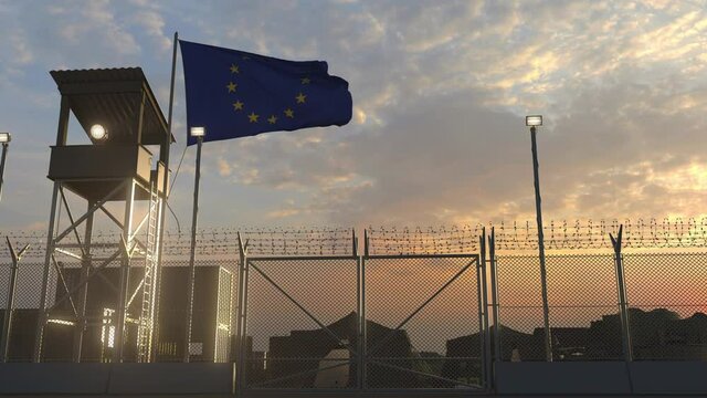 Waving flag of the European Union above military base in the evening