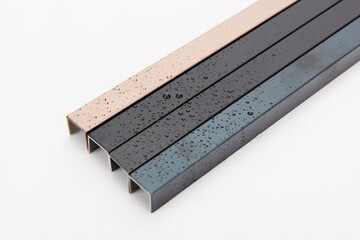 Various materials and colors of metal and steel are placed flat against a white background.