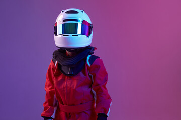 Cool boy child racer in helmet, racing suit, standing in neon light. Kart racing school poster. Competition announcement - obrazy, fototapety, plakaty