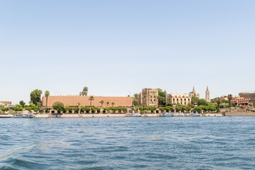 Luxor, Egypt: Panorama of river Nile in Luxor city, view from a boat. Residental buildings and sailboats.
