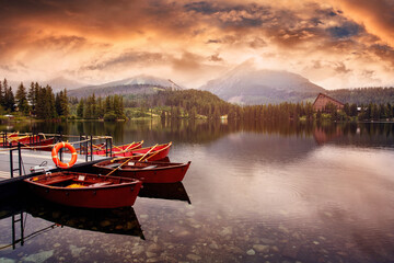 Boat on lake Strbske pleso in the background of the high peaks of mountains.