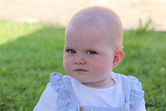 Baby girl seven months old full face image blue eyes blonde hair 