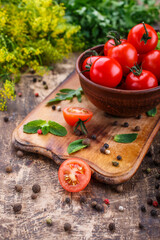 Cooking background. Fresh vegetables and peppers on wooden background. Ripe tomatoes and herbs