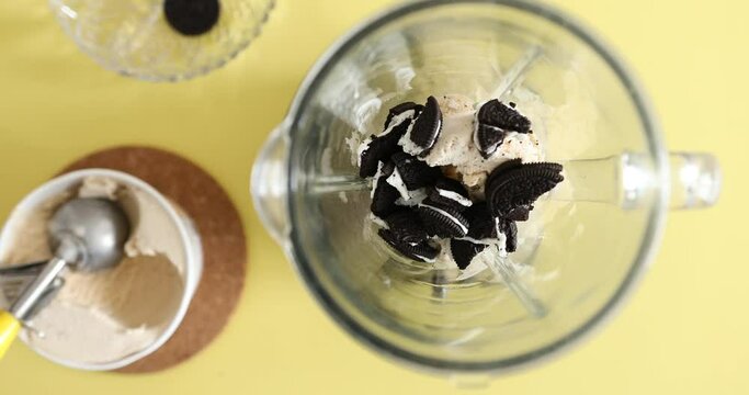 Mixing ice cream, cookies and milk together in blender