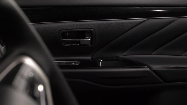 Panning of the interior of a luxury car with leather upholstery doors and seats