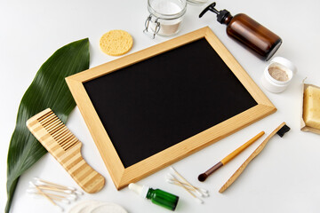 beauty, sustainability and eco living concept - natural cosmetics, bodycare eco products and chalkboard on white background