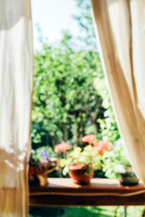 Blurred background of beautiful view from the balcony on a garden. Romantic morning abstract background.