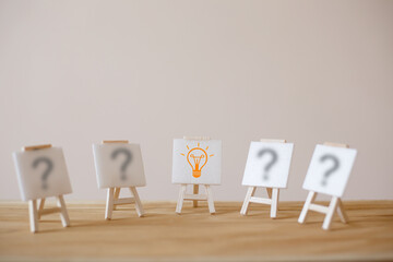 Outstanding sign stand with a light bulb icon and question mark symbol. Concept creative idea and innovation. Organization resource and talent management