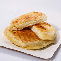 Fried potato pies. Patties with dill. Cheap recipe for homemade fried pies on a white background. Side view.