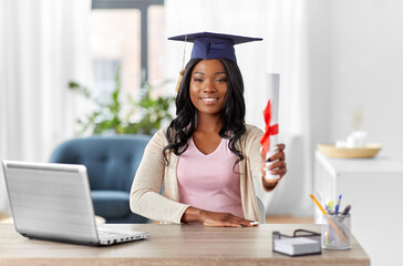e-learning, education and people concept - happy smiling african american female graduate student...