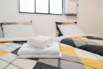Folded white towels placed on the bed.