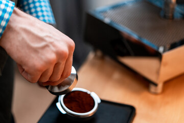 Close Up Of Barista Hands Holding Portafilter With Ground Coffee. Coffee Preparation At Home. Good Coffee Without Leaving Home