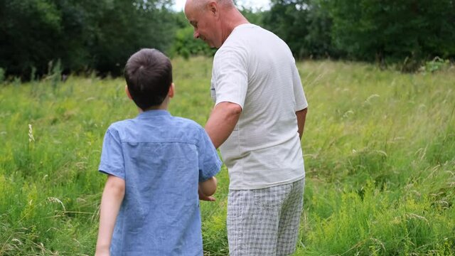 family, man and children walk among meadows and forests in summer, the concept of family summer vacations, picnics, vacations, camping, activity in the park