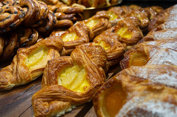 Croissants and cakes on a wooden table