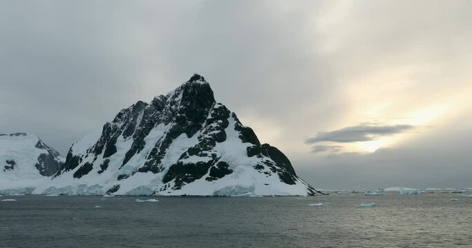 WS Lemaire Channel with snow covered mountain at sunset / Antarctica