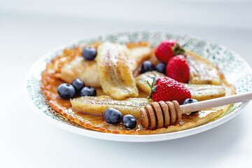 Pancakes with bananas and berries