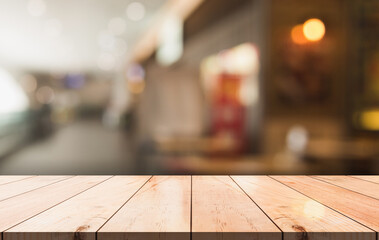 Empty wooden table top with lights bokeh on blur restaurant background