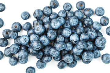 Tasty blueberries fruit are scattered on a white background.