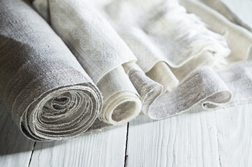 Old homespun and modern factory linen fabrics in rolls