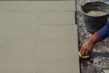 cement surface adjusting with hand of worker and waiting for cure by sunligth in out door in hands hold spong