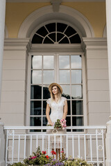 Portrait of blond woman in white dress