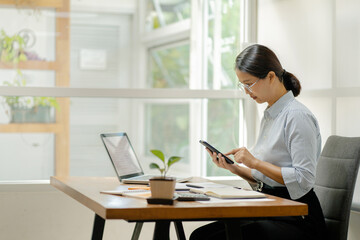 Smart asian woman using cell phone at home, Online learning.