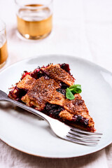 Slice of Delicious Homemade Berries Honeysuckle Pie on beige linen tablecloth. Selective focus
