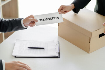 Businessman with resign letter for quit a job.