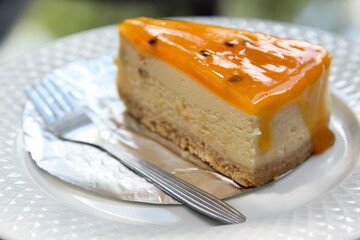 A piece of passion fruit cake on white plate.