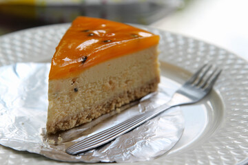 A piece of passion fruit cake on white plate.