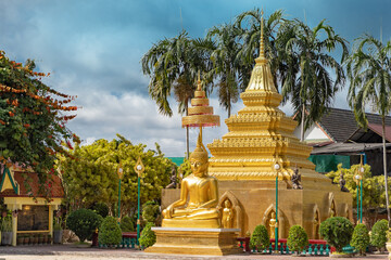 Fototapeta premium golden buddha image statue with pagoda in south of Thailand