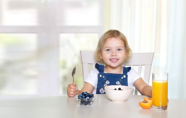 Child girl eating empty copy space food advertisement display.Kid's nutrition.