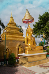 Fototapeta premium Złoty posąg Buddy z pagodą w południowej Tajlandii
