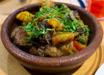 Close up shot of the traditional Georgian food. Odjahuri or Adjahuri - baked meat with potato and seasoning. Caucasian traditional cuisine. 