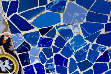 Close up shot of the glazed Spanish mosaic. Blue gradient pattern. Geometric background. Multi-colored ceramic pieces. 