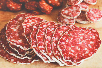 Traditional salami sliced on cutting board