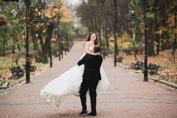 Perfect couple bride, groom posing and kissing in their wedding day