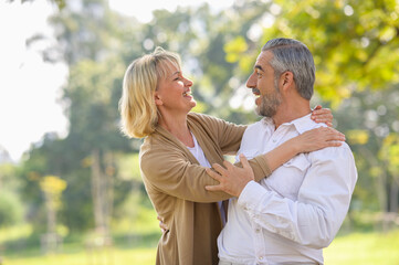 Health care happy senior lifestyle concept : Portrait photo of old happy senior caucasian couple smiling and relaxing in outdoor park on sunny day, hoot senior couple relax in spring or summer time.