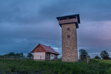 Sunset in summer rainy evening near Roprachtice village with observation tower