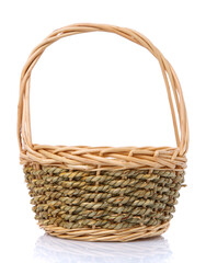 Basket woven in two colors from a natural vine isolated on a white background.