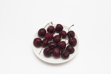 Fresh red Cherries on the dish isolated 
