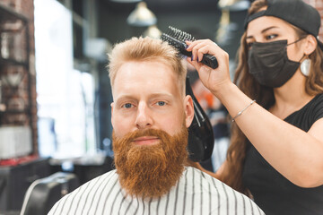 Portrait of a customer with a female hairdresser in a salon