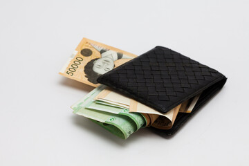 Paper korea won banknotes in old leather purse