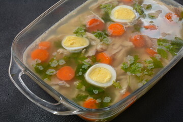 Home made aspic, jellied chicken meat with herbs and carrots. Traditional Russian dish holodets. Served with bread and mustard or/and horseradish