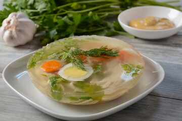Home made aspic, jellied chicken meat with herbs and carrots. Traditional Russian dish holodets. Served with bread and mustard or/and horseradish