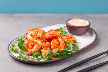 Hot appetizer fried king shrimps, arugula, sauce